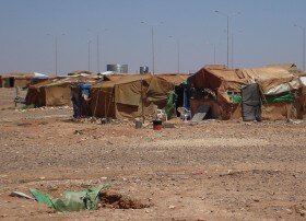 Tattered tents bake in the sun in Ruweishid, Jordan. Many Iraqis became stranded here in 2006 after fleeing violence in neighboring Iraq. shot by Brian Conley